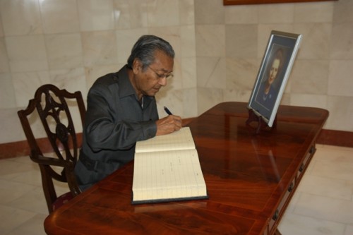 Former Malaysian Prime Minister Tun Mahathir signing a condolence book in memory of Lady Thatcher