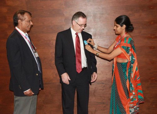 Sri Lanka's Legal Aid Commission pin the white ribbon onto British High Commissioner John Rankin