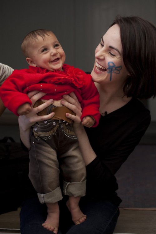 Michelle Dockery holding a baby at the Zaatari Camp for Syrian Refugees. Photo taken by: Abbie Traylor-Smith/Oxfam