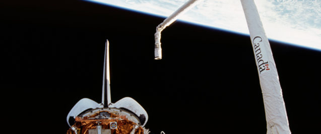 Canadarm (right) during Space Shuttle mission