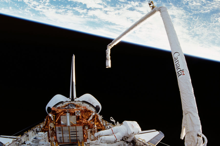 Canadarm (right) during Space Shuttle mission