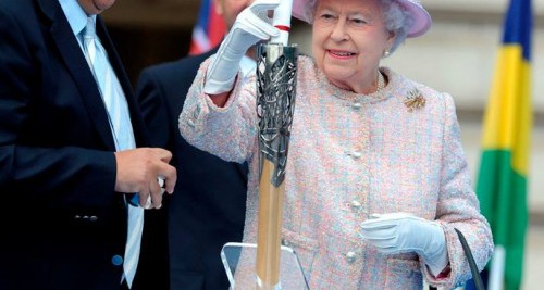 Her Majesty placing her message into the Baton