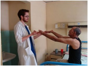 Toby Rowland examining a patient in Santiago