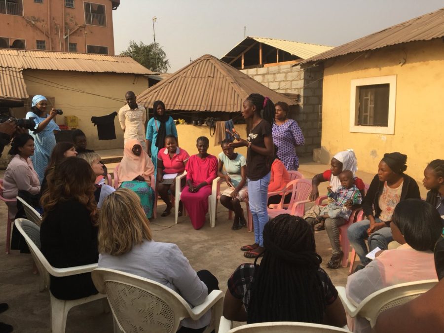A circle of women and girls talking in Nigeria.